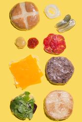 Ingredients of a cheese burger wrapped in plastic