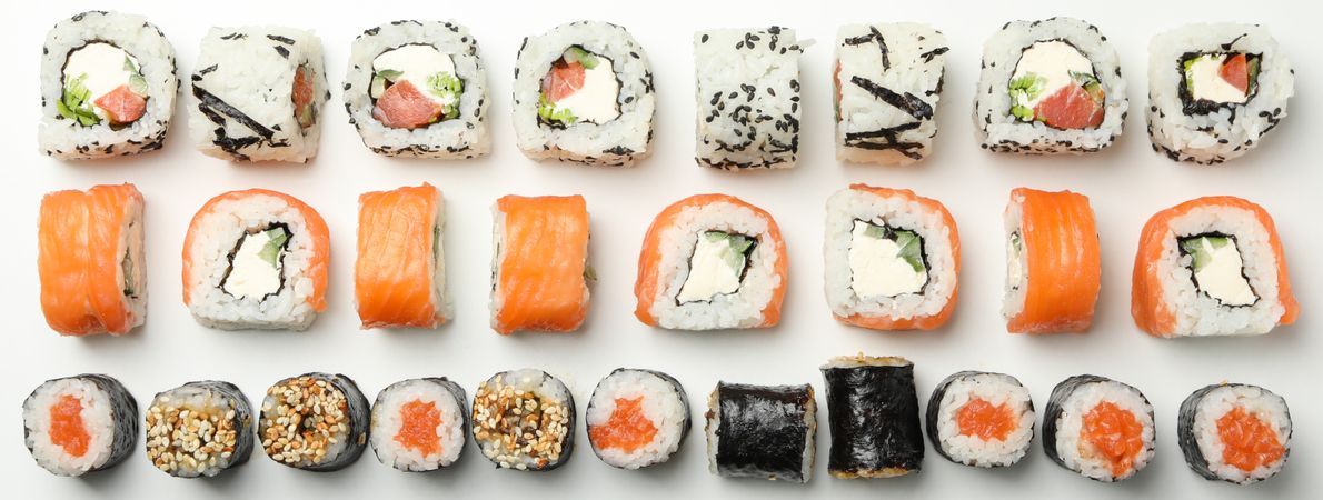 Flat lay with sushi rolls on blank background. Japanese food