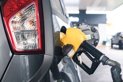 Close up of gas handle filling up vehicle