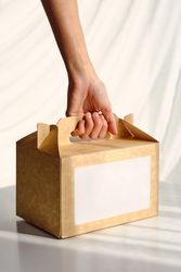 Woman taking carton box for delivery