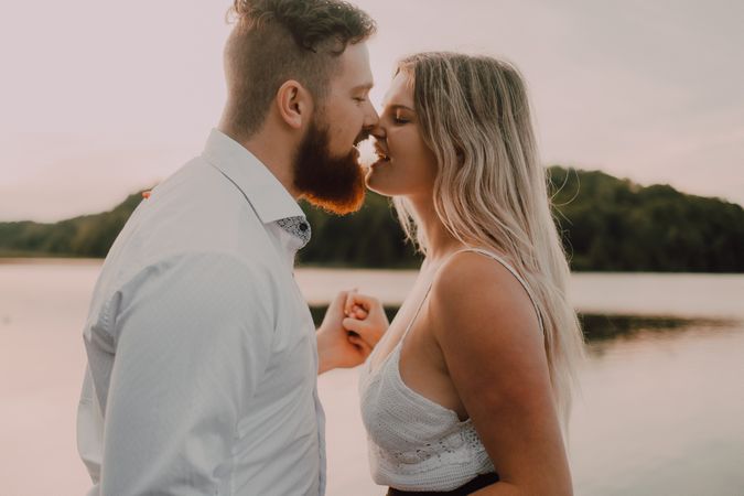 Loving couple standing ankle deep in water on beach