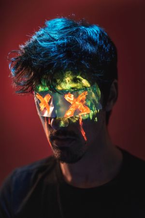 Male with covered eyes and neon face