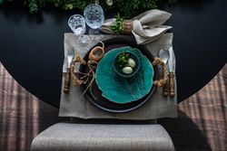 Looking down on Easter table setting with decorative teal plate