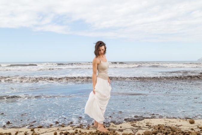Charming young woman on shore near water