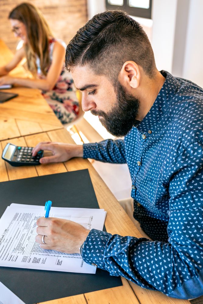 Adviser filling in tax documents in office