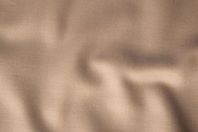 Wavy smooth pattern brown fabric background texture.