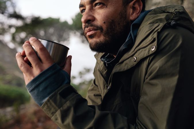 Male hiker taking rest and drinking fresh coffee