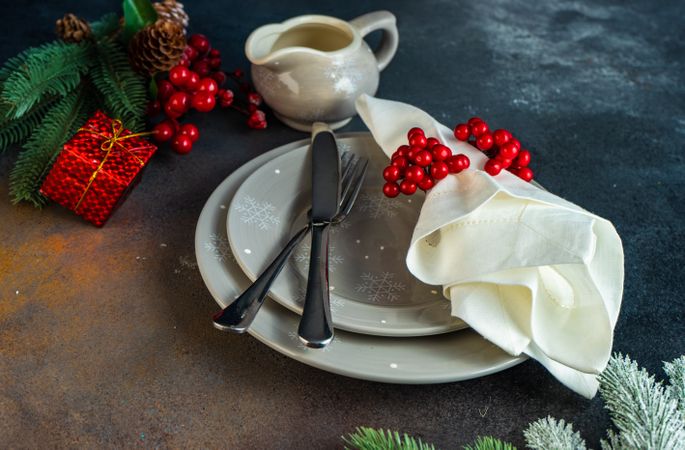 Holiday table setting with grey plates and gravy boat