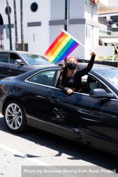 Los Angeles, CA, USA — June 14th, 2020: woman waves rainbow flag out of car window at BLM protest 56Gze4