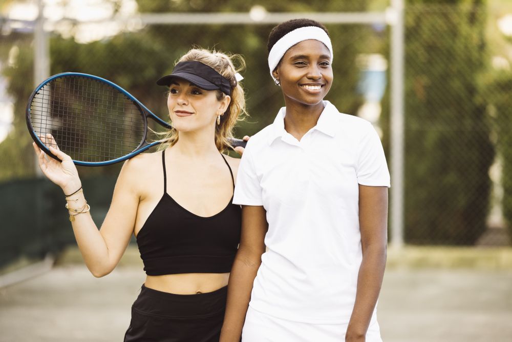 Portrait of two young women on a tennis court