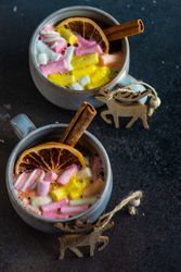 Top view of marshmallow drink in mugs with reindeer