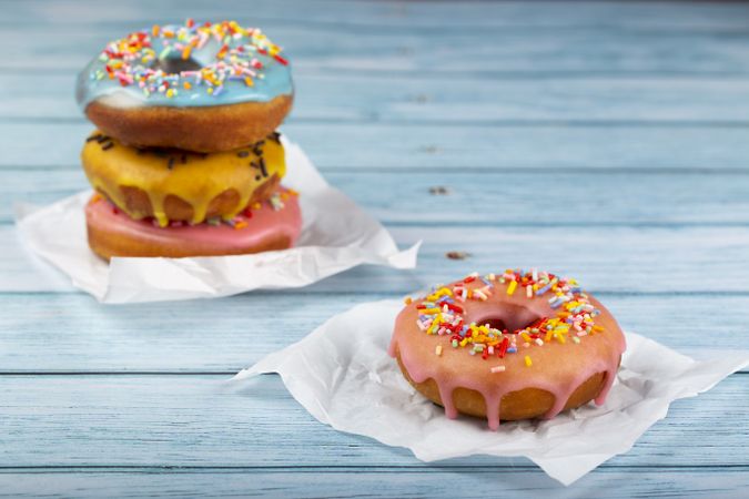 Delicious assorted colorful donuts on the table.