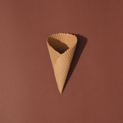 Ice cream cone on brown background
