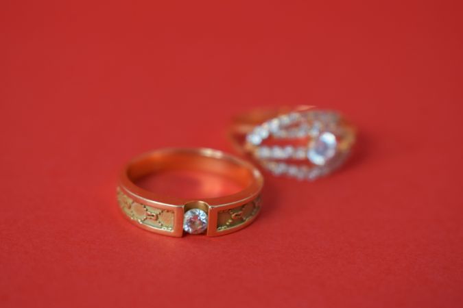Two diamond rings on red background