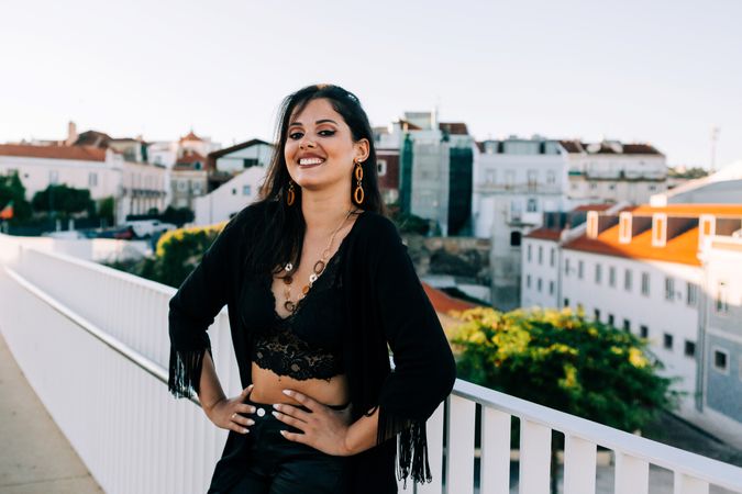 Trendy female standing on urban background