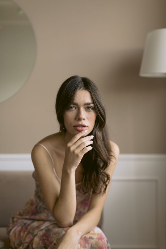 Portrait of a woman with her hand on her face looking into camera