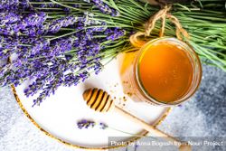 Top view of honey pot with dipper and bunch of lavender 5oDEOk
