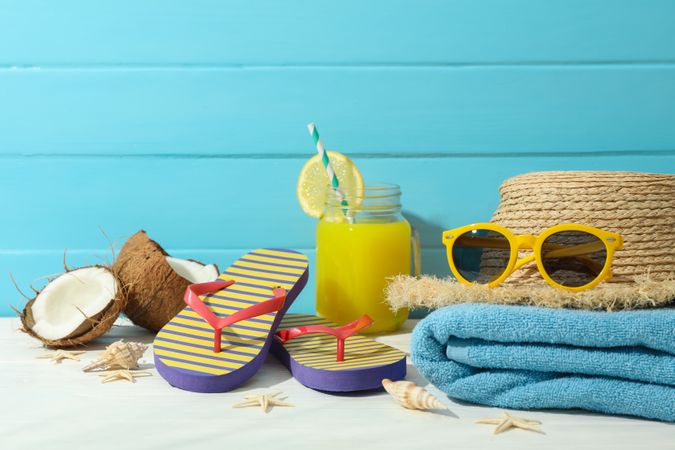 Summer vacation accessories on table against color wooden background, space for text. Happy holidays