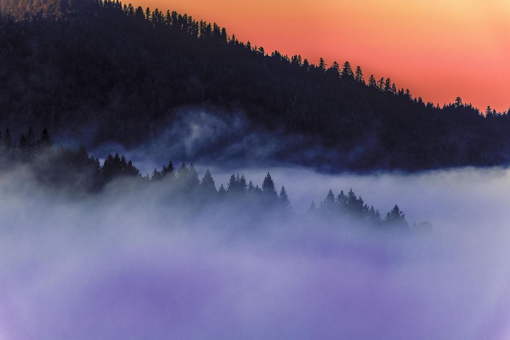 Cloudy day in the mountain at orange sunset or sunrise