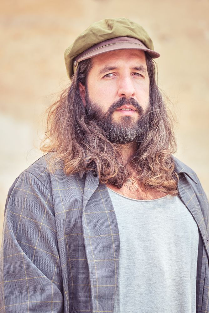 Brutal hipster man looking at camera