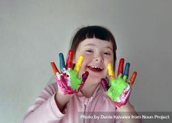 Creative young girl painting with her fingers 5QQA95