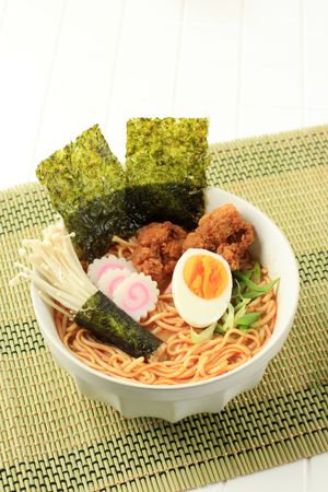 Bowl of spicy ramen noodles with nori and chicken