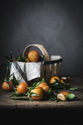 Mandarins and basket on table