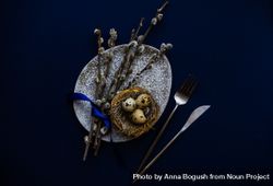 Top view of blue table and bird's nest on grey table for Easter table setting 4OdrRZ