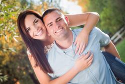 Happy Romantic Couple Piggybacking in the Park.