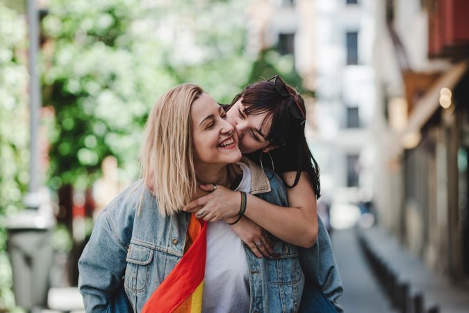 Happy lesbian couple having fun on street