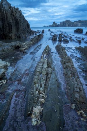 Foggy landscape of Playa de Gueirua rock seashore