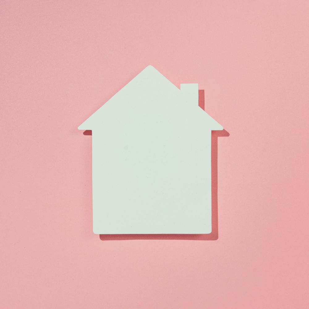Paper house on pink background