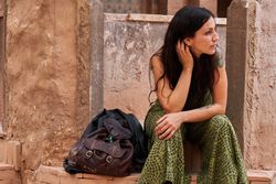 Woman on street between ancient buildings
