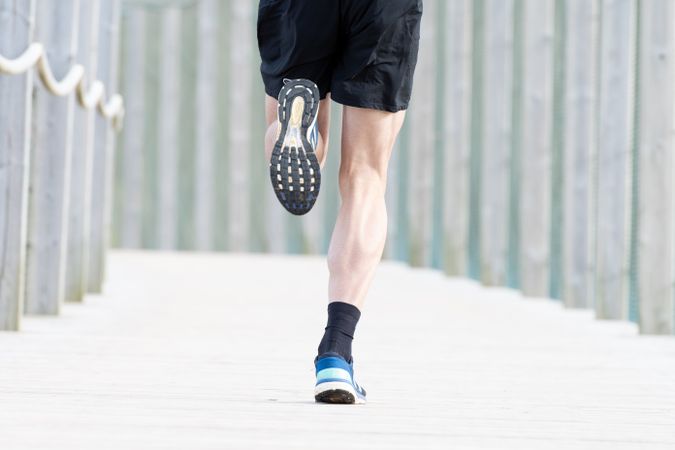Sportsman jogging outdoors under cover