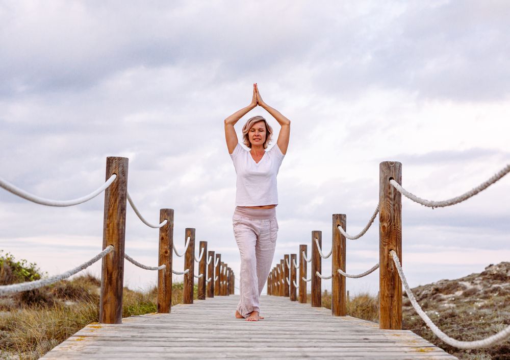 Cheerful woman exercising on timber path