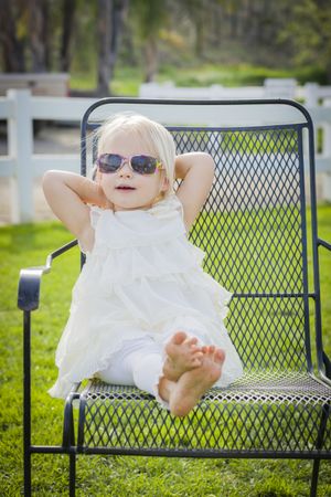 Cute Playful Baby Girl Wearing Sunglasses Outside at Park