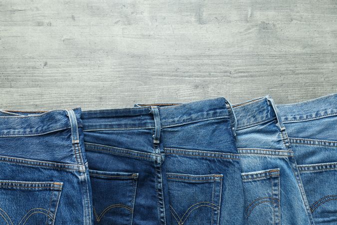 Folded jeans on a wooden background