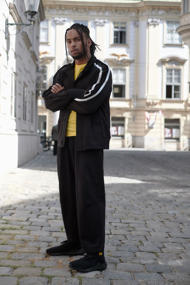 Black male standing with arms crossed