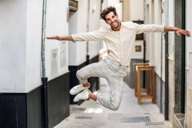 Young funny man jumping in the street