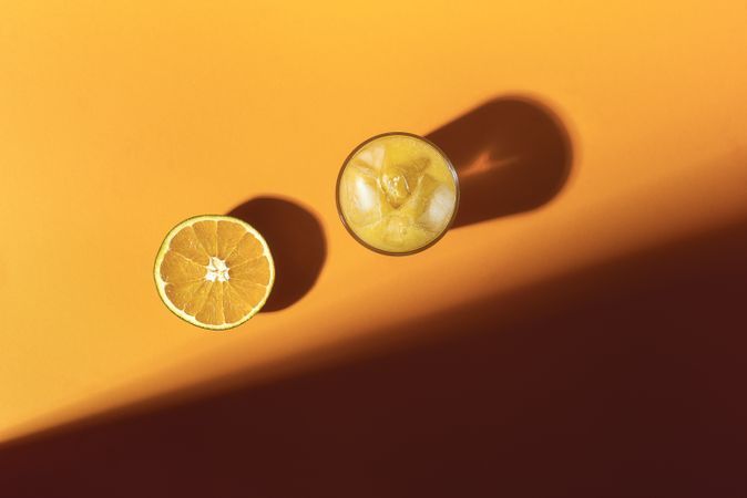 Orange fruit and cold orange juice in sunlight