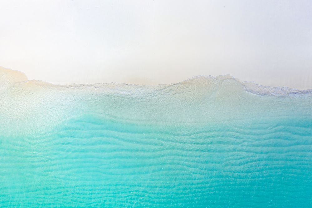 Aerial shot of the clear sea at a tropical beach