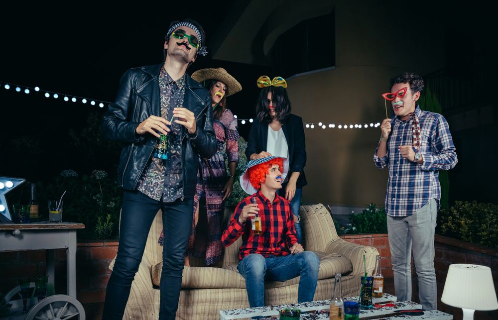 Friends goofing around in costumes at party