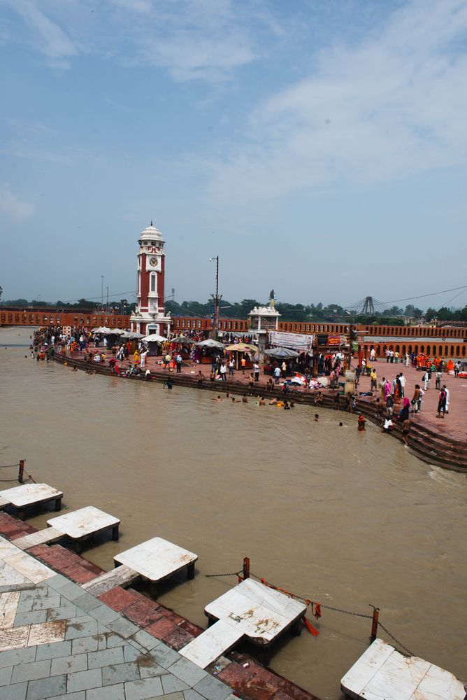 Crowds of people bathe in Ganges river in Rishikesh, India