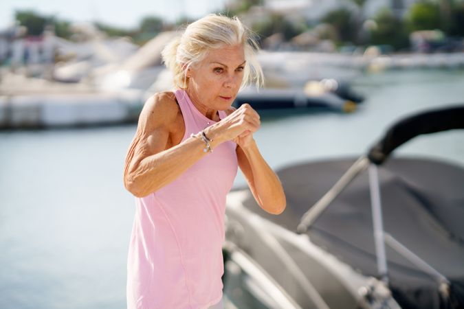 Older woman doing sport in a coastal port