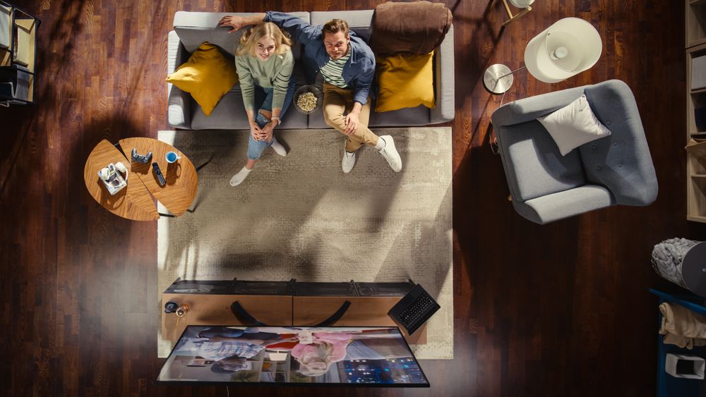 Top View Apartment: Lovely Happy Couple Watching Television in the Loft Living Room.