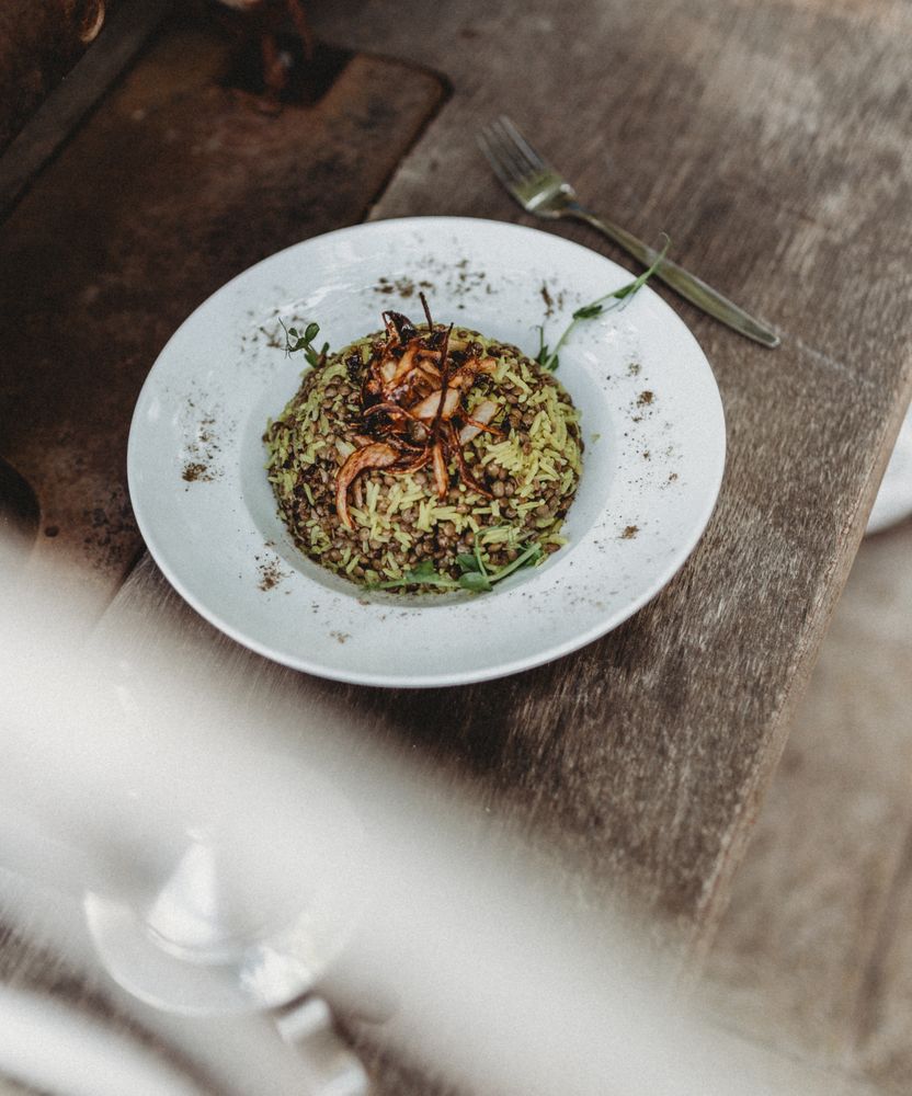 beans hummus in plate close to vegetables plateplate of delicious Mujaddara