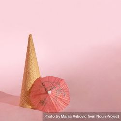Cone of ice cream with pink cocktail parasol 5Xlzk5