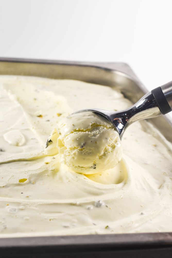 Scooping out a ball of pistachio ice cream