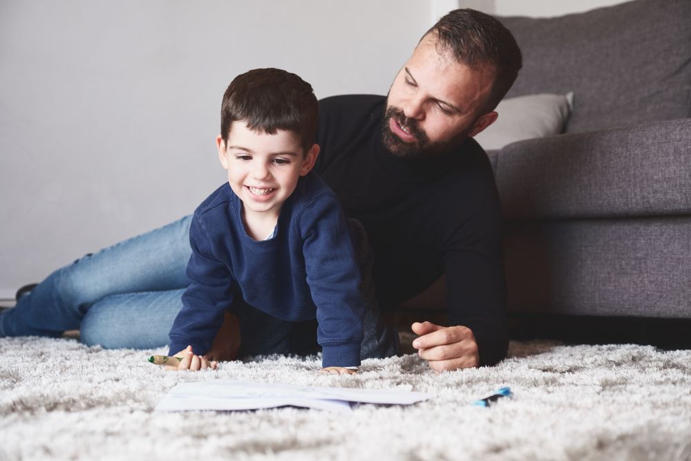 Father and son drawing on floor