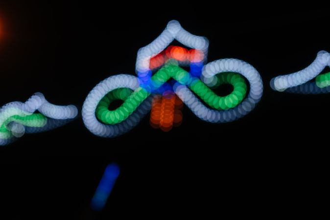Glowing sign of amusement ride on fairground